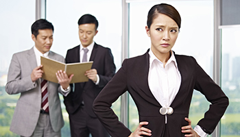 Unhappy woman with her colleagues