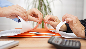 business meeting manager and employee destroy draft of document